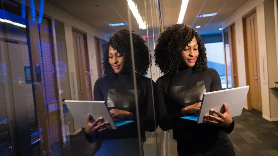 Team members using tablets and laptops to access a business system